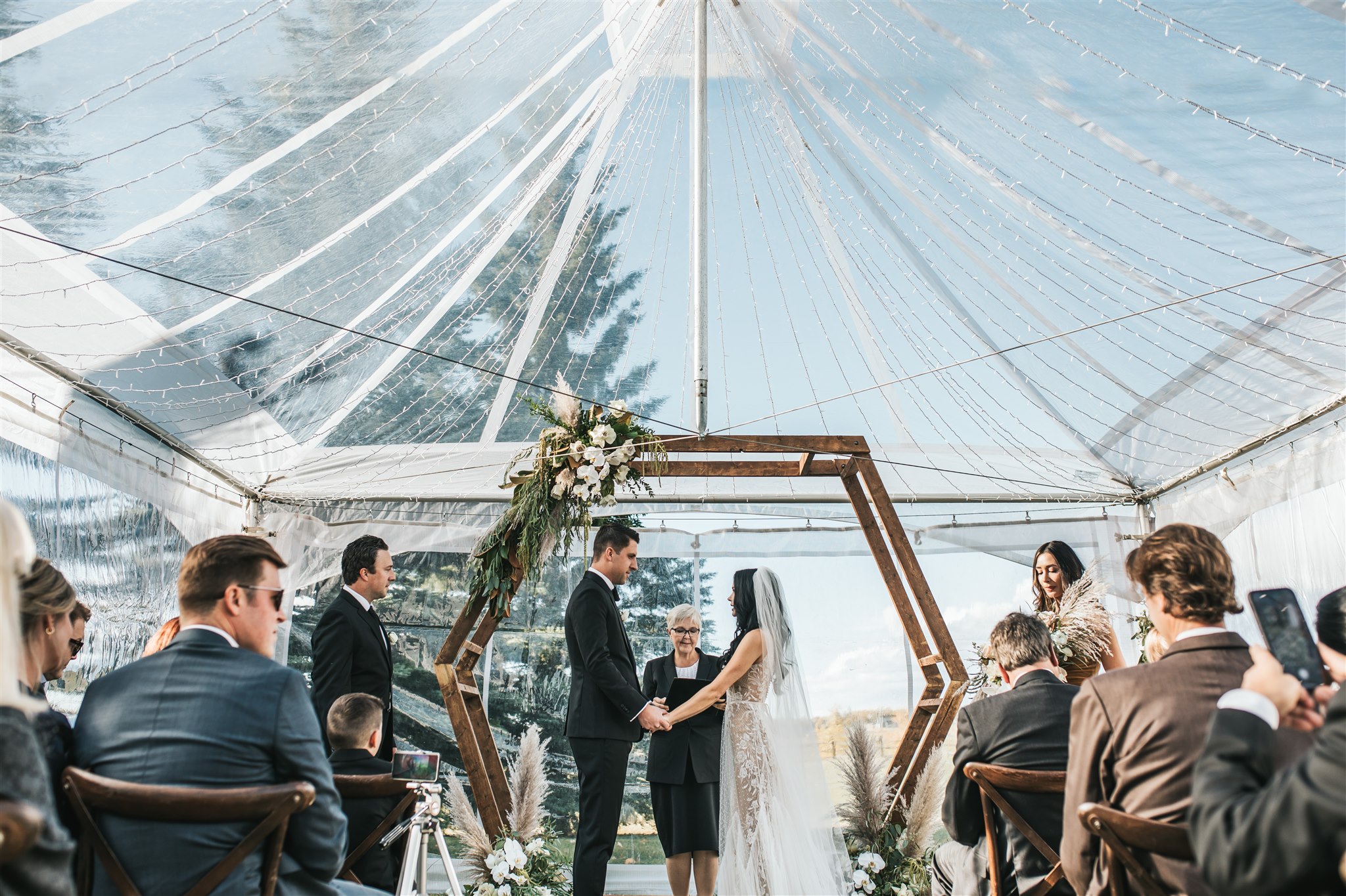 Bride and Groom during ceremony in tented springbank calgary acreage wedding