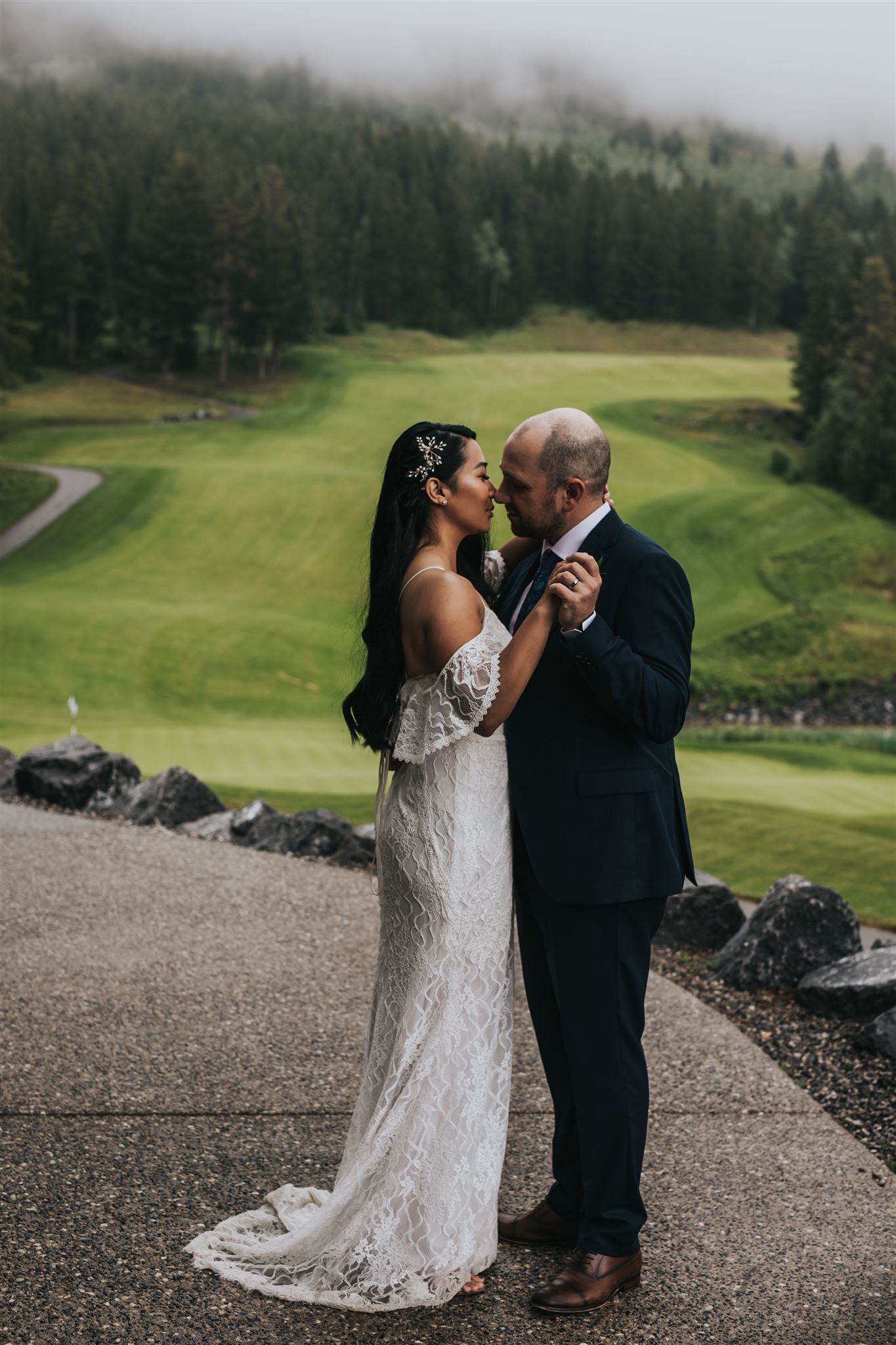 Bride and Groom Portraits in the rain at silvertip resort in canmore, alberta