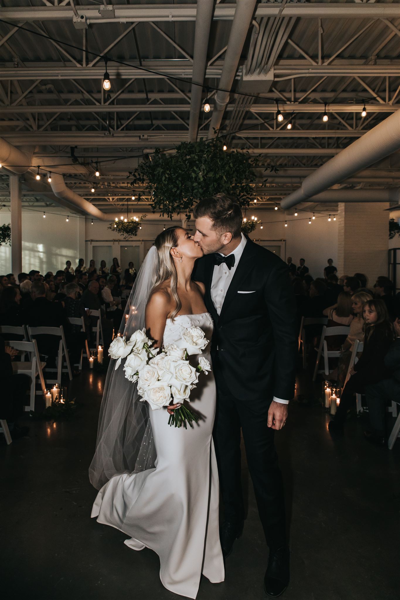 Bride and Groom kissing at the end of the aisle at The Brownstone