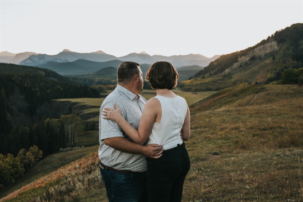 Couple embraced during Engagement session overlooking mountains