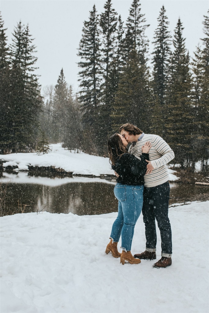 Couple embracing for engagement photos with Sue Moodie Photography in the woods