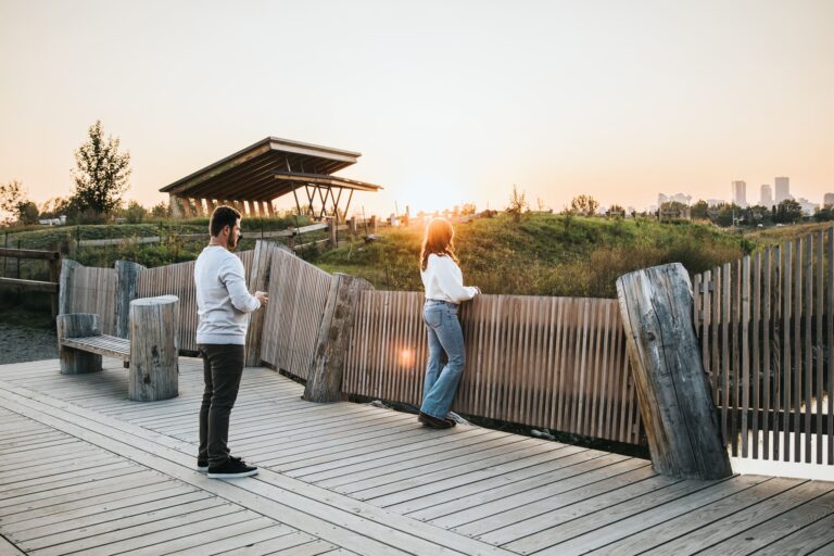 Couple enjoying sunset view at Calgary's outdoor park during fall engagement session bu Calgary Engagement Photographer Sue Moodie Photography